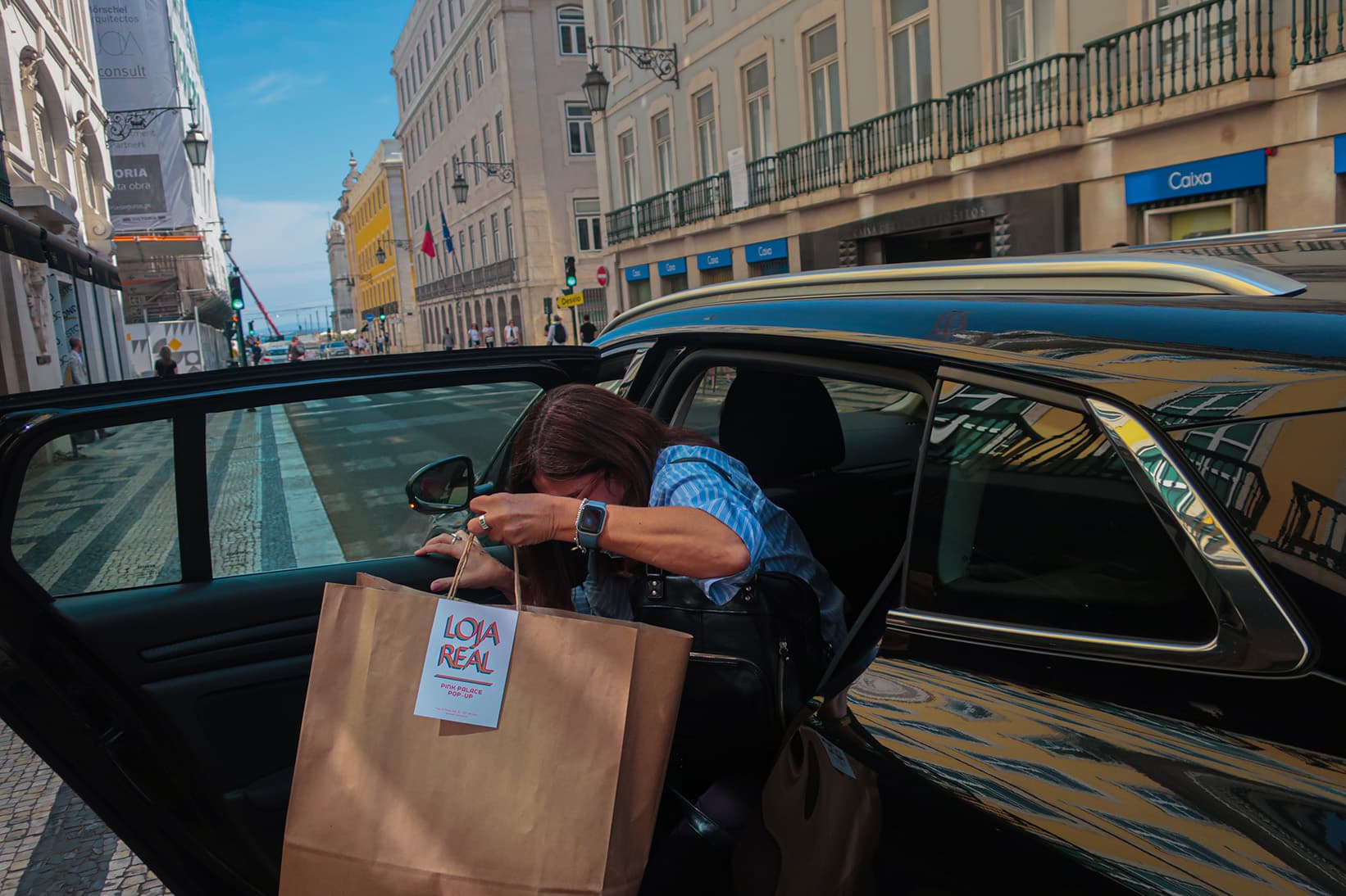 A women getting out of a car with her purchases